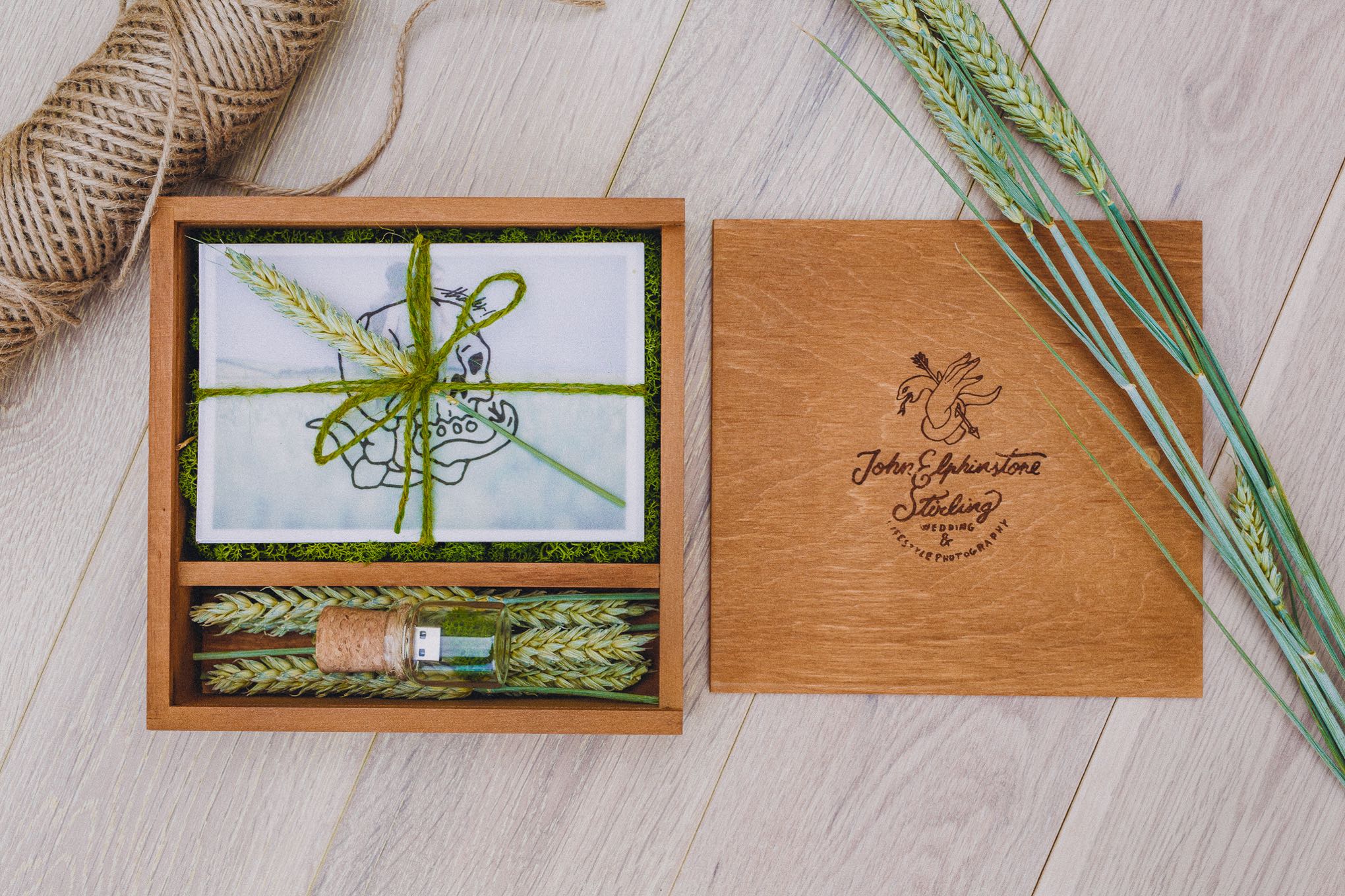 Handcrafted alderwood wedding keepsake box containing printed photographs and a USB, styled with natural twine and dried wheat, showcasing a tactile heirloom alternative to digital galleries, relax natural wedding photographer Glasgow Scotland