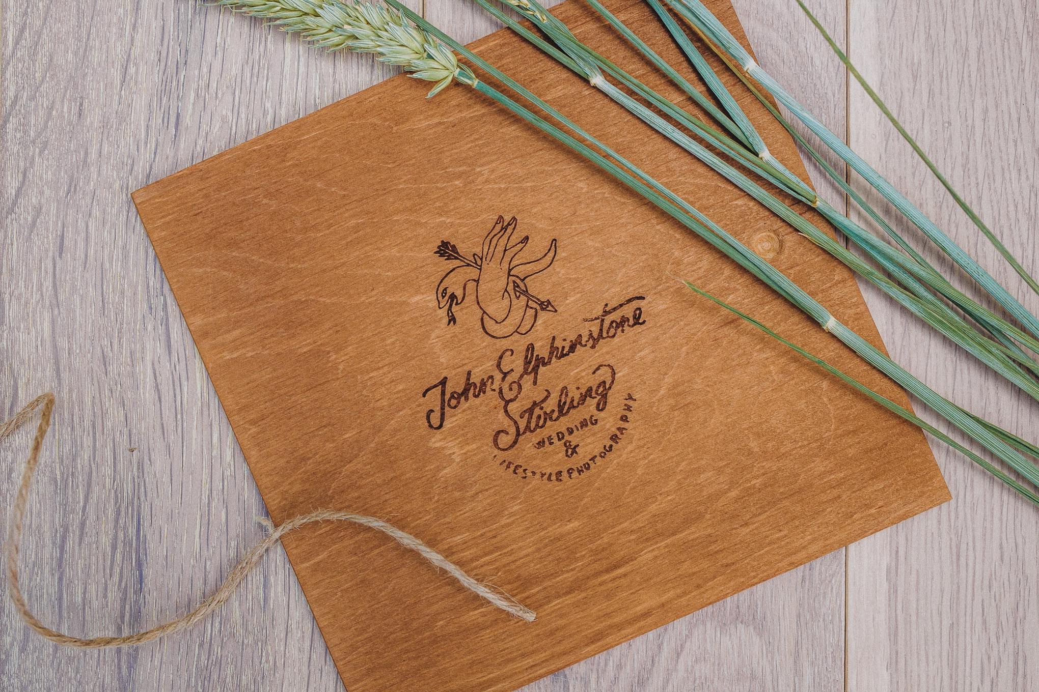 Handcrafted alderwood wedding keepsake box containing printed photographs and a USB, styled with natural twine and dried wheat, showcasing a tactile heirloom alternative to digital galleries, relax natural wedding photographer Glasgow Scotland